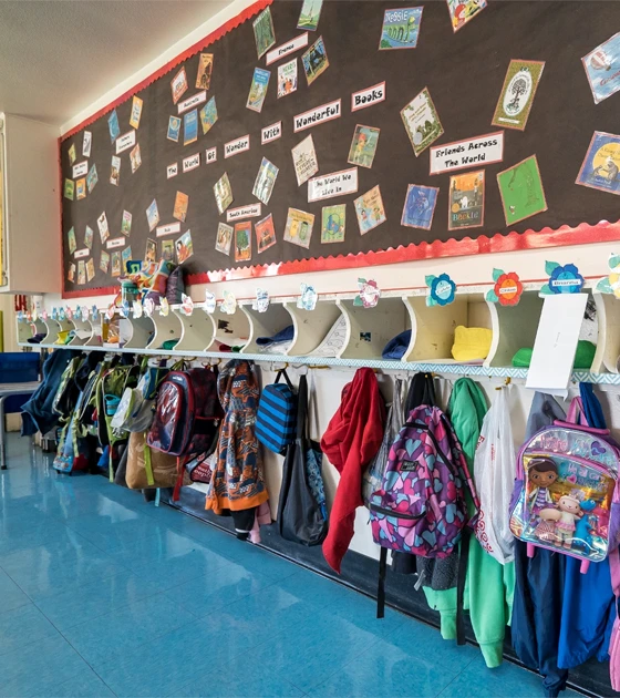 Classroom cubbies and a wall of storybooks
